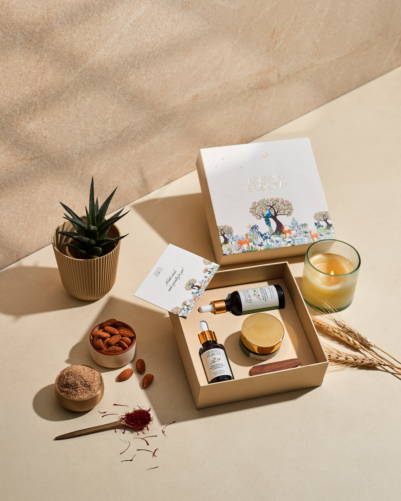 Open Aranya Bloom gift box with two bottles and a jar arranged inside.