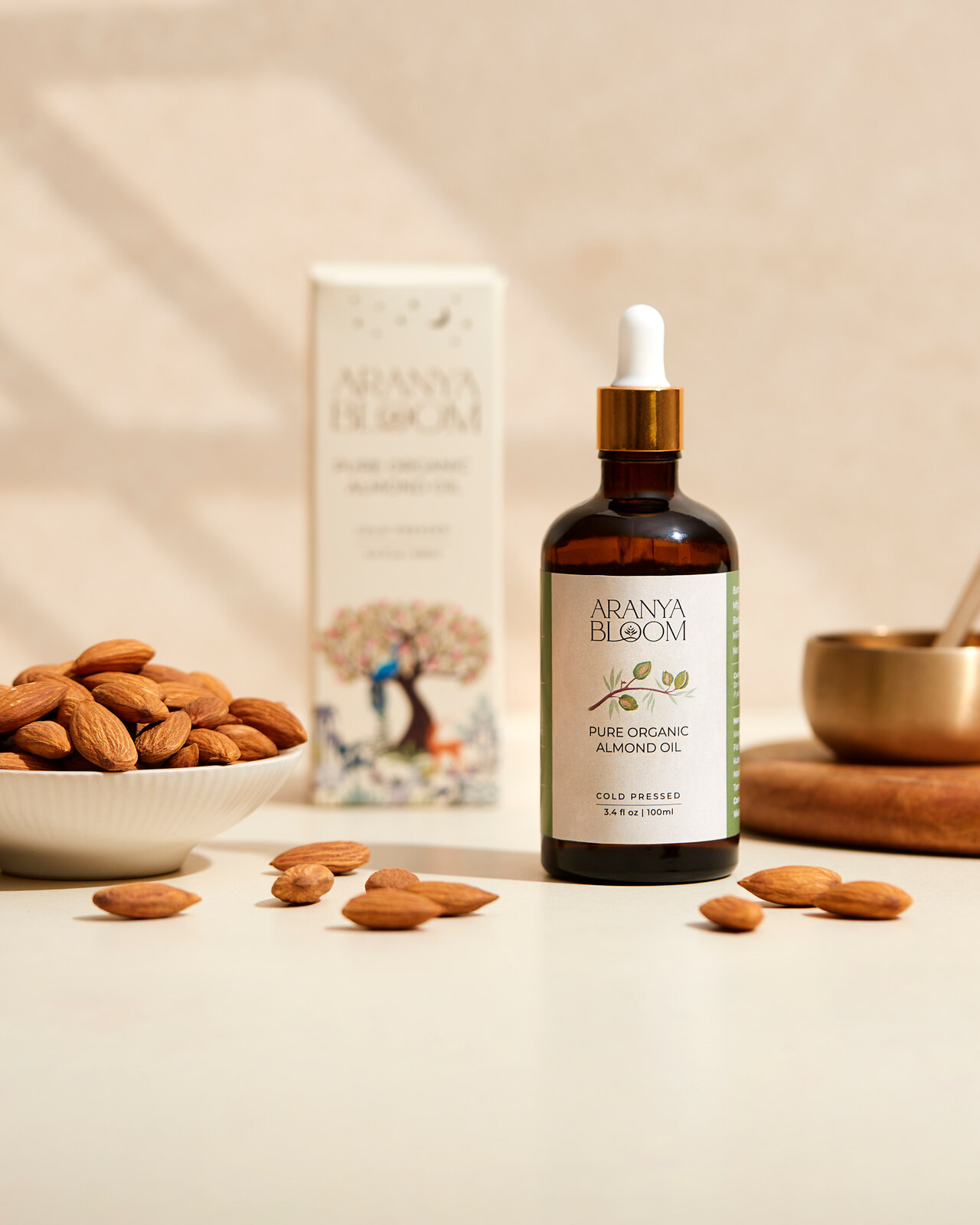 Aranya Bloom almond oil bottle and carton on a warm neutral surface.